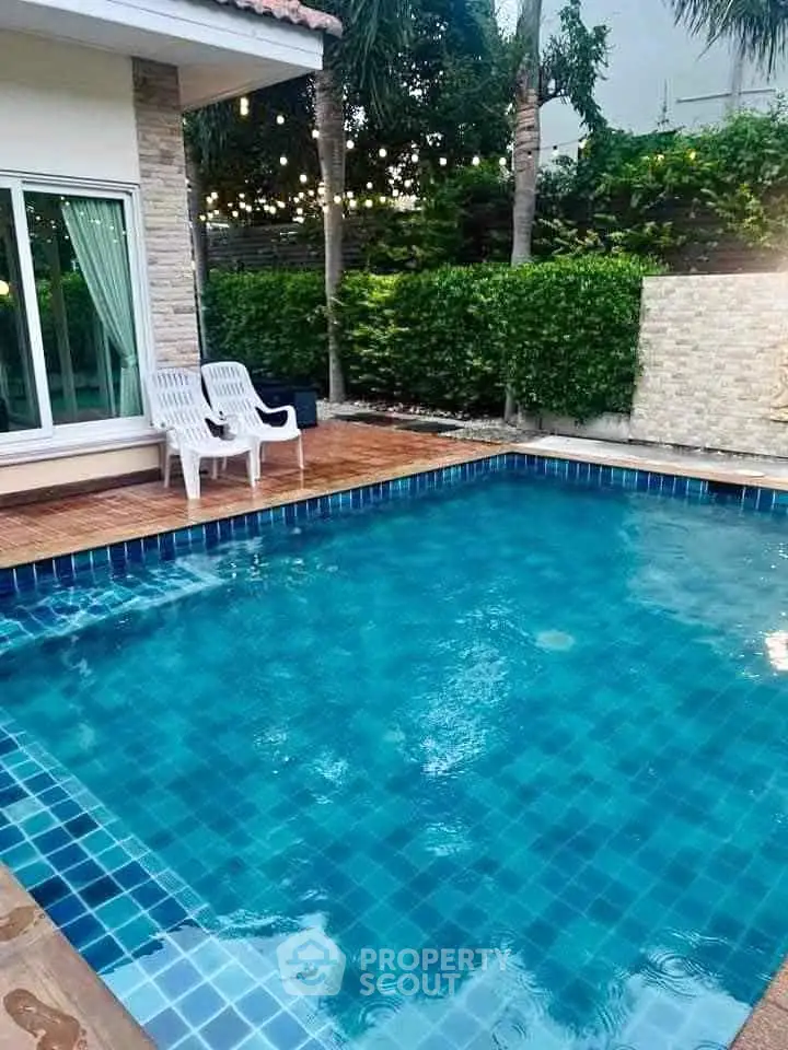 Luxurious private pool with elegant tile design and lush greenery, perfect for relaxation and entertainment.