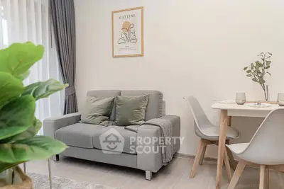 Cozy living room with modern decor and dining area, perfect for relaxation.