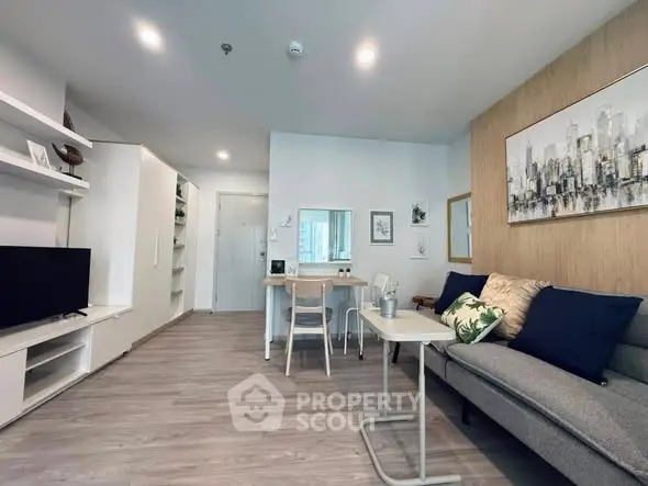 Modern living room with stylish decor and open layout, featuring a cozy sofa and sleek furniture.