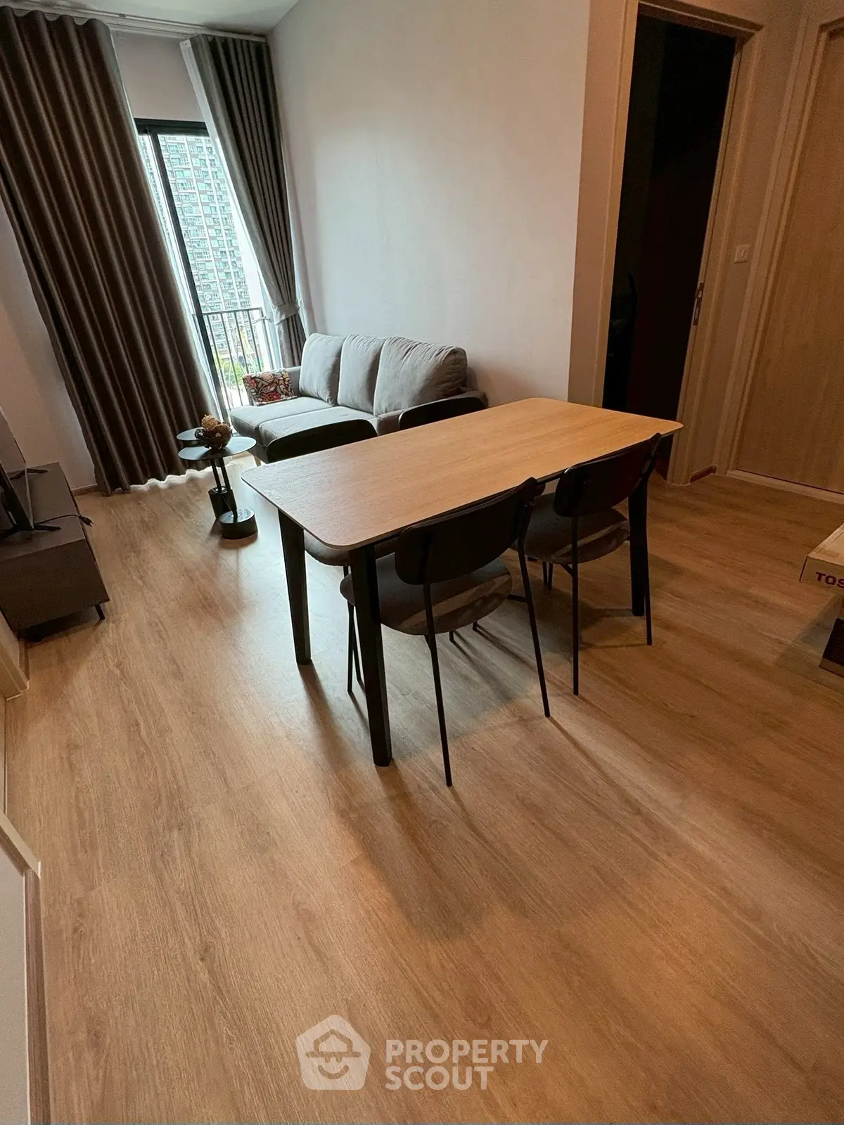 Modern living room with wooden flooring and stylish furniture in a cozy apartment.