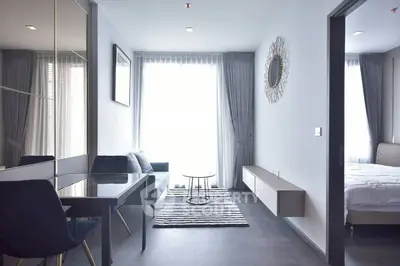 Modern living room with sleek furniture and natural light in a stylish apartment.