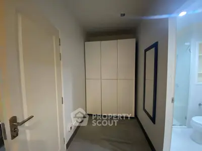 Compact hallway with storage and bathroom access in modern apartment