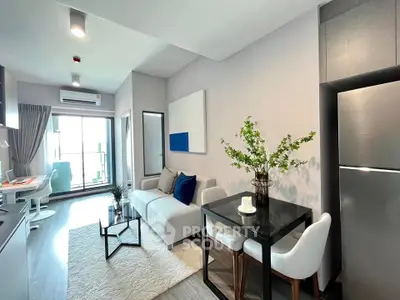 Modern living room with stylish decor and balcony view in a contemporary apartment.