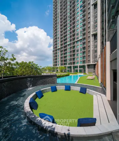 Luxurious high-rise apartment with stunning pool and modern outdoor seating area.