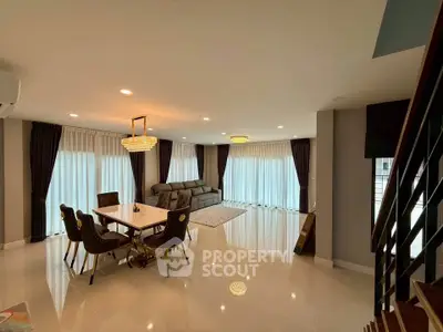 Spacious modern living room with elegant dining area and luxurious lighting