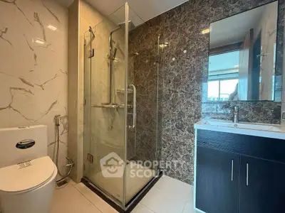 Modern bathroom with glass shower and marble accents