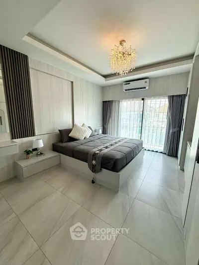 Luxurious modern bedroom with elegant chandelier and large windows