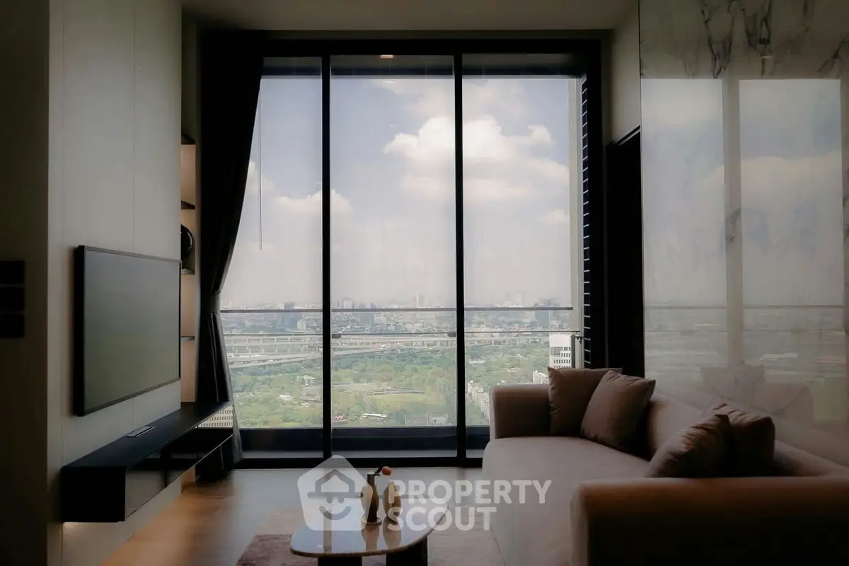 Luxurious living room with stunning city view through floor-to-ceiling windows, modern decor and cozy seating.