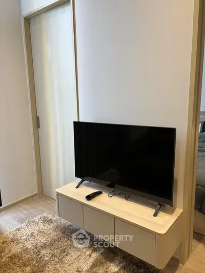 Modern living room with sleek TV stand and cozy carpet