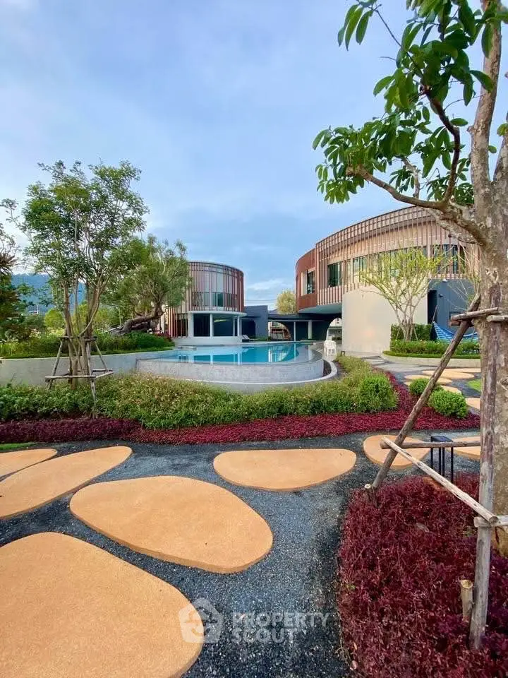 Luxurious modern villas with a stunning pool and lush garden landscape.