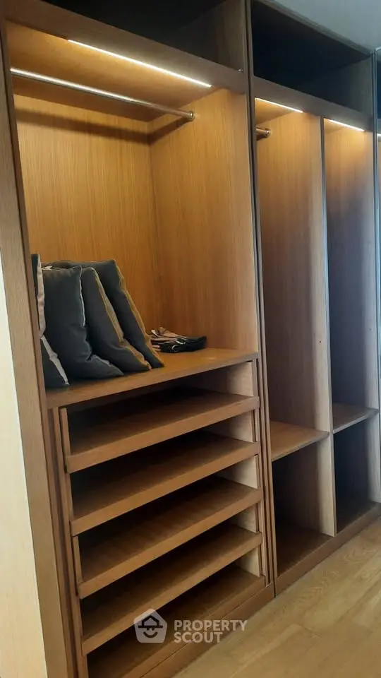 Spacious wooden walk-in closet with shelves and hanging space
