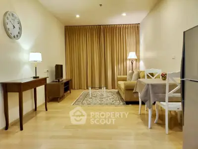 Cozy living room with elegant decor and warm lighting, featuring a comfortable sofa and stylish dining area.