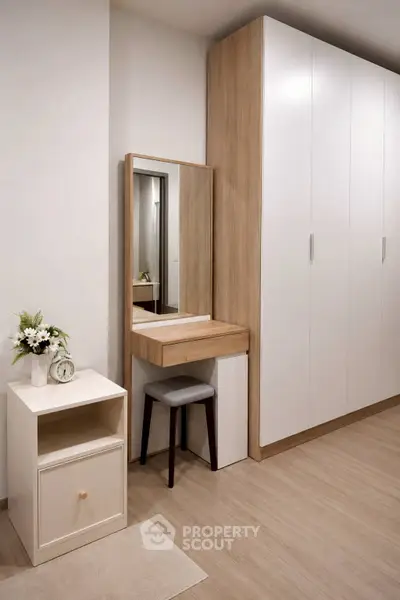 Modern bedroom with sleek wardrobe and stylish vanity area
