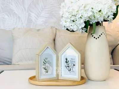 Elegant living room decor with floral arrangement and framed art on a stylish tray.