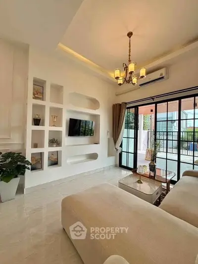 Elegant living room with modern decor and large windows for natural light.