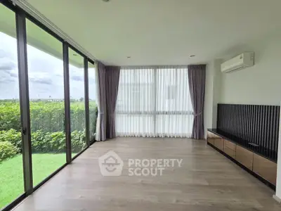 Spacious corner unit living room with large windows and garden view, perfect for natural light lovers.