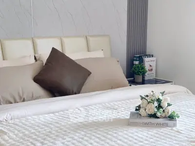 Elegant bedroom with plush bedding and stylish decor, perfect for a cozy retreat.