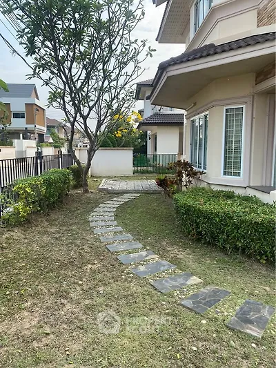 Charming suburban home with lush garden and stone pathway, perfect for family living.