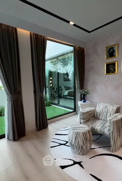 Elegant living room with large window, stylish armchair, and modern decor.