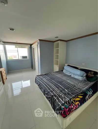 Spacious bedroom with modern design and ample natural light