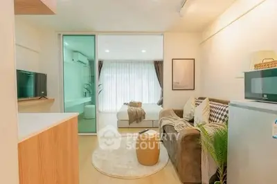 Modern open-plan living room with cozy decor and natural light