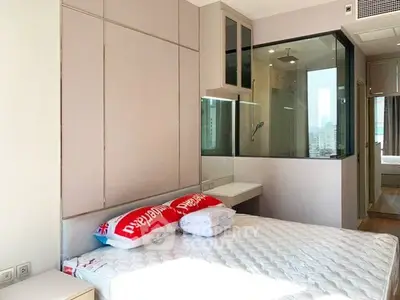 Modern bedroom with glass partition and city view, featuring sleek design and natural light.
