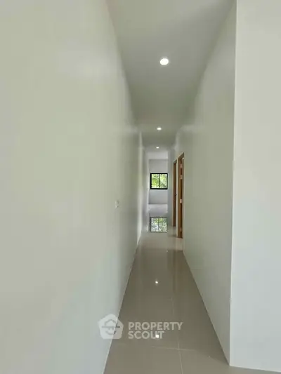 Sleek modern hallway with glossy tiled floor and recessed lighting