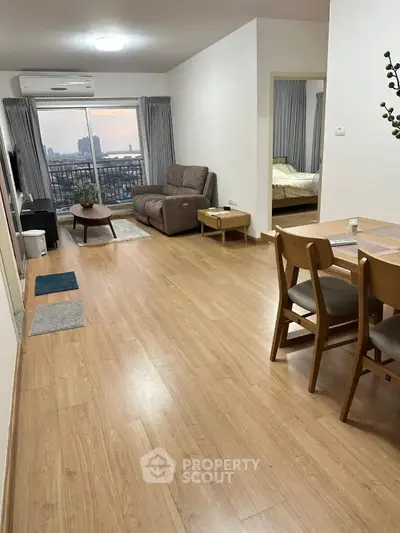 Spacious modern living room with wooden flooring and city view