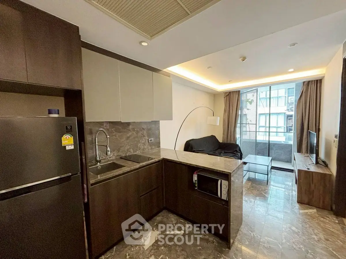Modern open-layout kitchen and living room with sleek design and natural light.