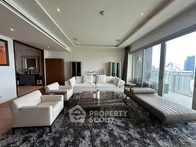 Luxurious modern living room with panoramic city view and elegant furnishings.