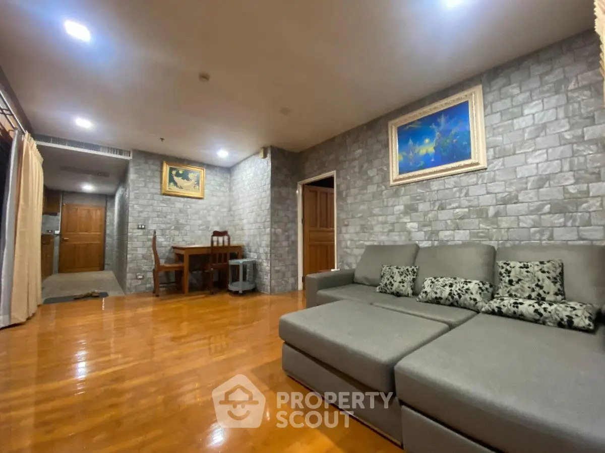 Spacious living room with modern decor and wooden flooring