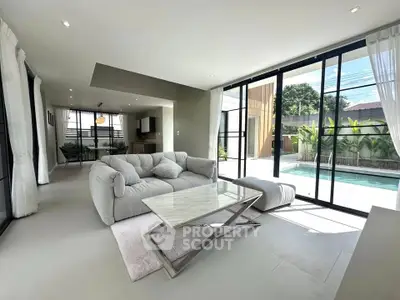 Spacious modern living room with pool view and elegant furnishings