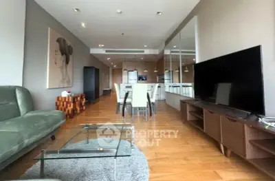 Spacious modern living room with elegant decor and open kitchen layout.