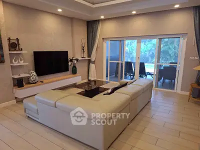 Spacious living room with modern decor and large sliding doors to balcony.