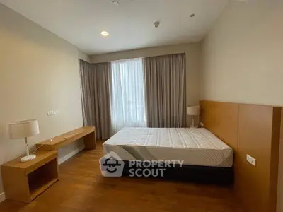 Spacious bedroom with natural light and modern furnishings