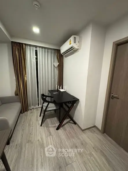 Modern living room with sleek furniture and air conditioning in a stylish apartment.