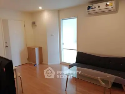Modern living room with sleek furniture and air conditioning in a cozy apartment.