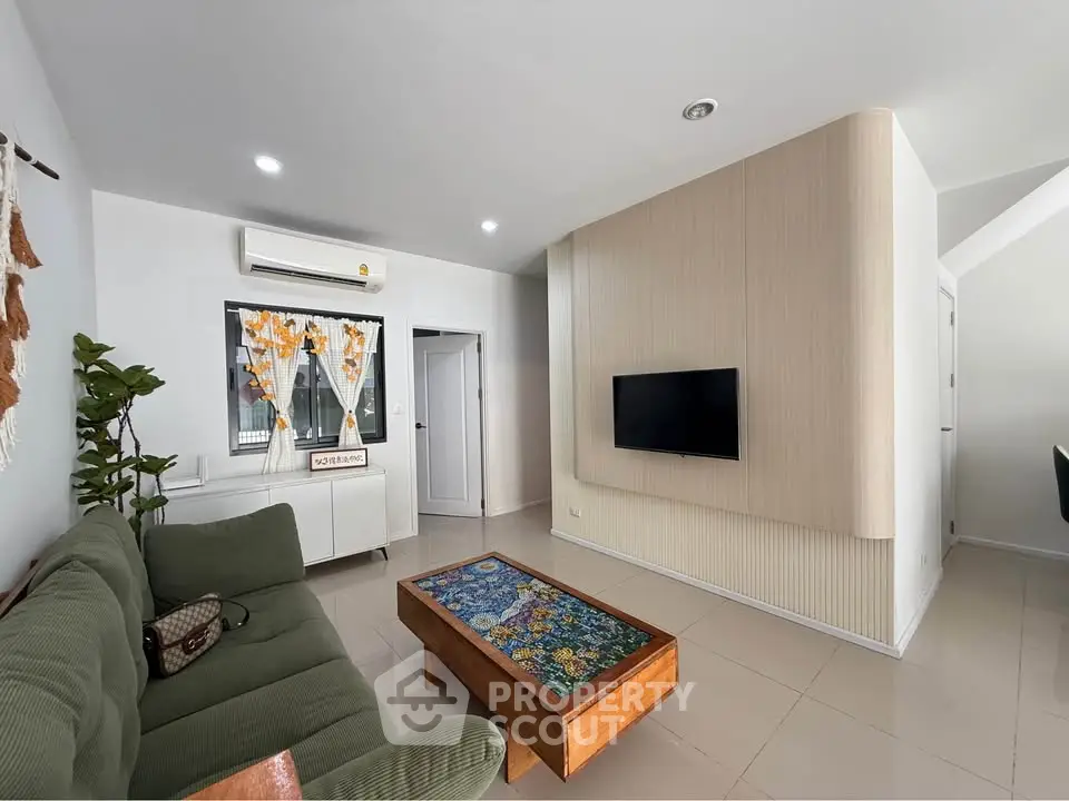 Modern living room with stylish decor and wall-mounted TV