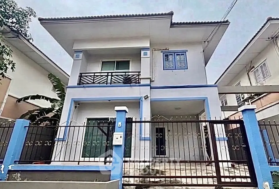 Charming two-story house with modern design and spacious front yard in a serene neighborhood.