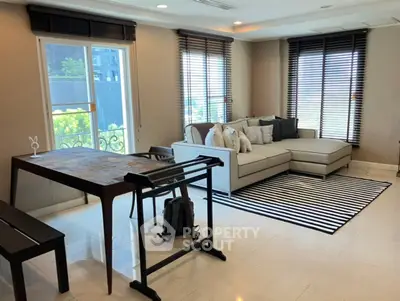 Modern living room with stylish furniture and large windows offering natural light.