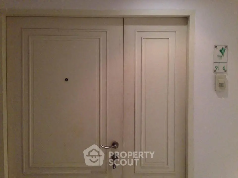 Elegant apartment entrance with double doors and modern handle