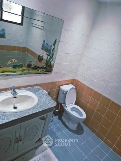 Charming bathroom with ocean-themed decor and modern fixtures