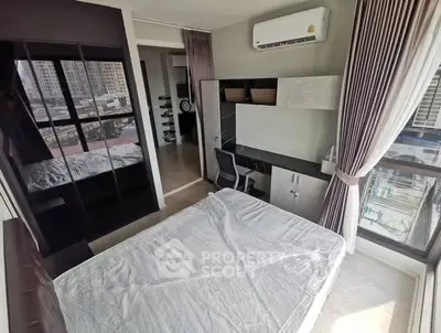 Modern bedroom with large windows and city view, featuring sleek furniture and air conditioning.