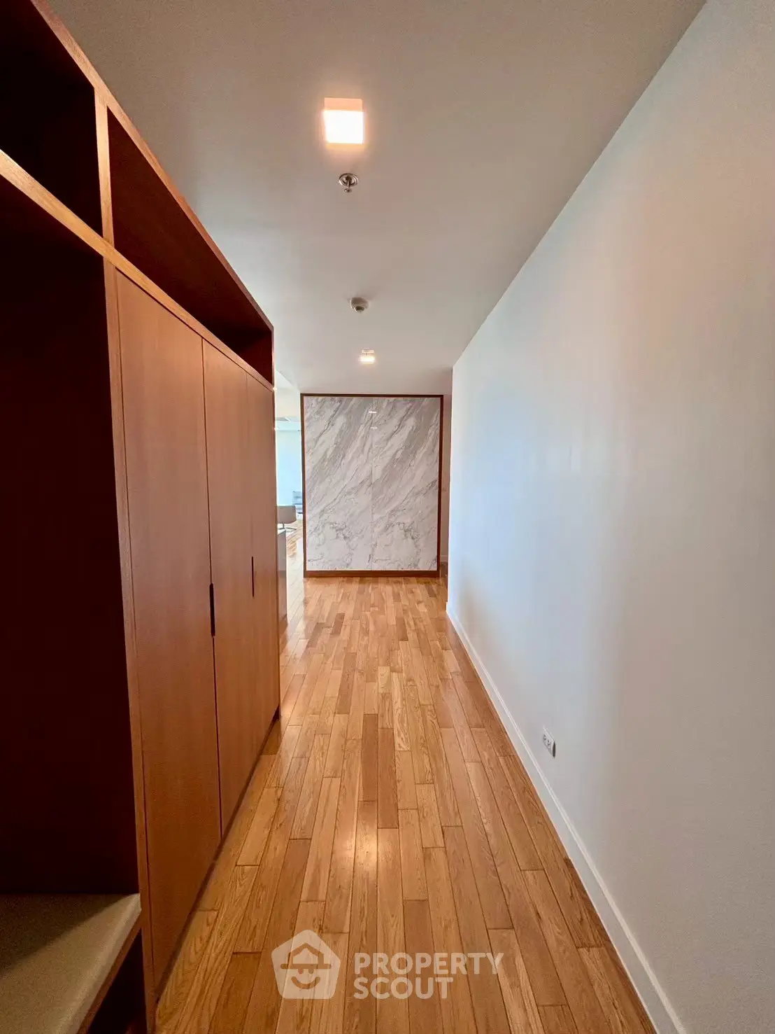 Elegant hallway with wooden flooring and modern design in upscale apartment