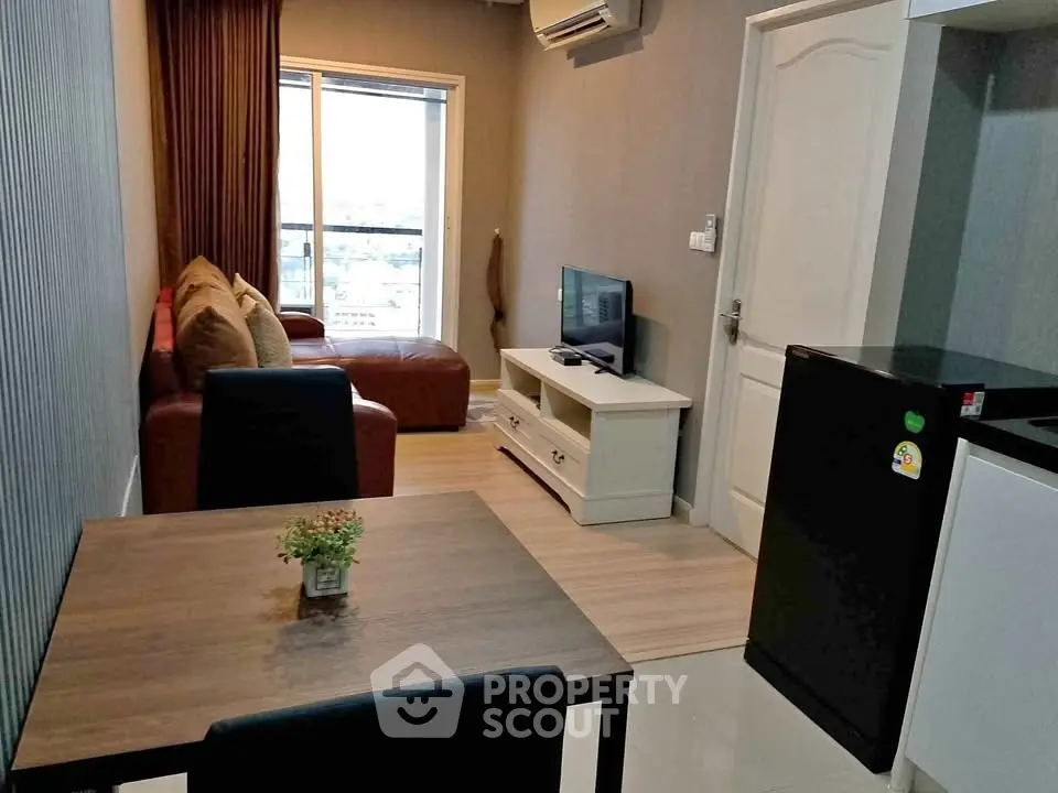 Modern living room with cozy seating and city view, perfect for urban living.