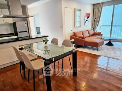 Modern open-plan living room with stylish furniture and wooden flooring