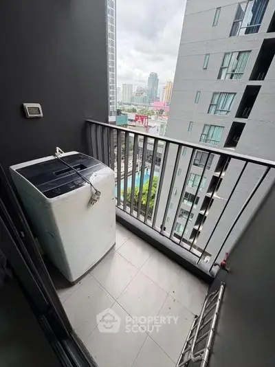 Modern apartment balcony with washing machine and city view