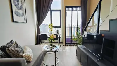 Modern living room with city view, stylish decor, and natural light