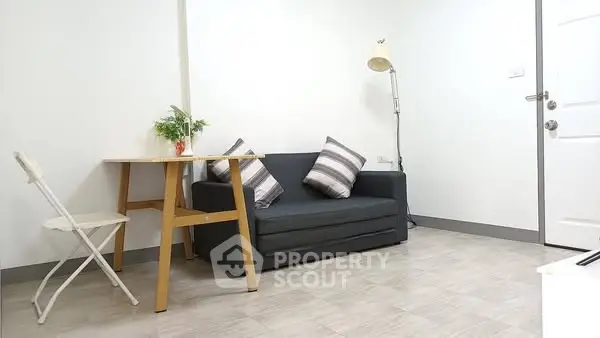 Cozy minimalist living room with modern furniture and natural light.