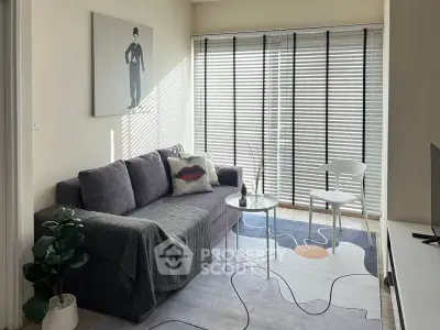 Charming living room with modern decor and ample natural light, featuring a cozy sofa and stylish blinds.